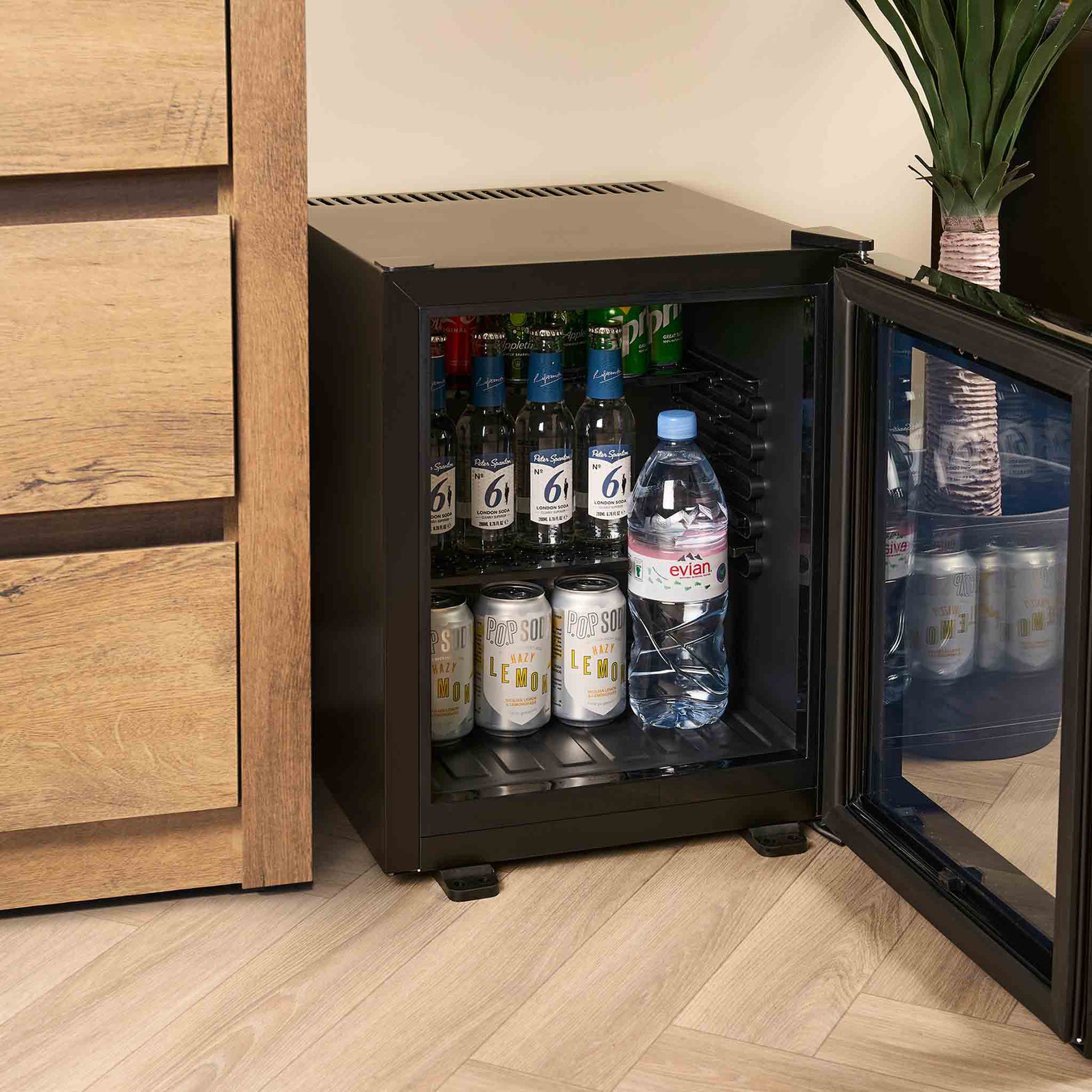 Lifestyle photo of 35 litre hotel mini bar with glass door and black interior