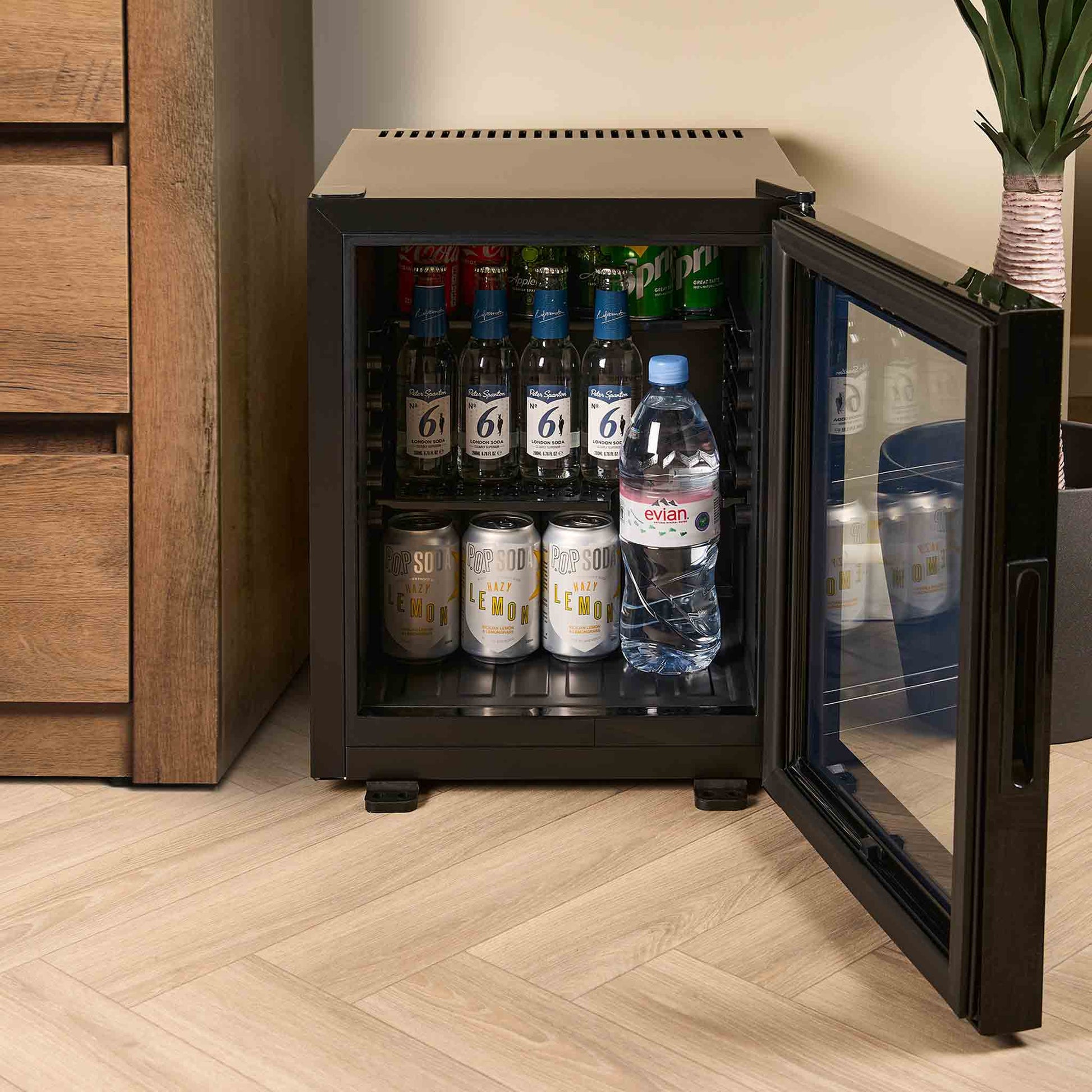 Hotel mini bar full of drinks in hotel room